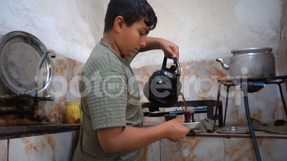 An Iraqi child pouring tea