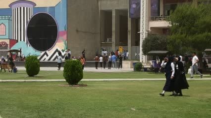Male and female students of the University of Mosul, during break time, in the university park