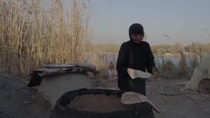 سيدة عراقية تحضر الخبز العراقي